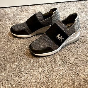 Michael Kors shoes silver sparkle with black logo band. New never used.